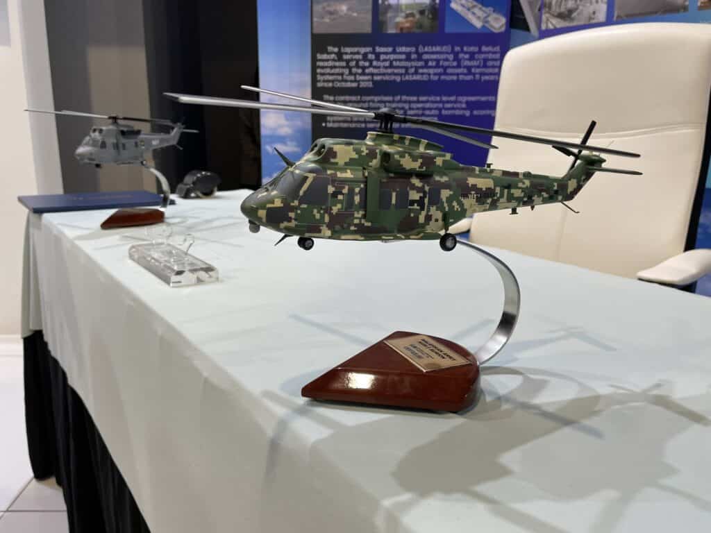 Scale models of a KAI Surion helicopter in Malaysian Army camouflage and a Marineon in Royal Malaysian Navy camouflage at the Kemalak Group's DSA 2024 booth (Albert Lee)